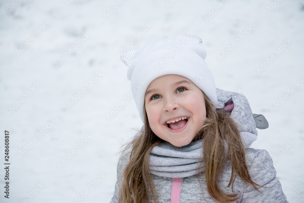 portrait of a beautiful little girl of 6 years in the winter park portrait of a beautiful little girl of 6 years in the winter park