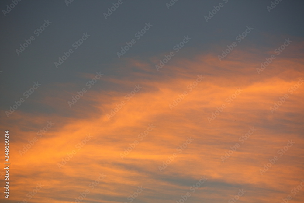evening clear blue sky with orange sunlight shine through cloud