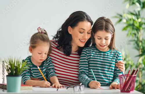 Mother and daughters drawing together