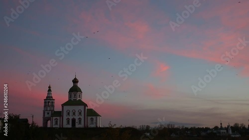 Flock of birds over the Ilinsky church in Suzdal at sunrise, Golden Ring of Russia.The sound - the cries of birds