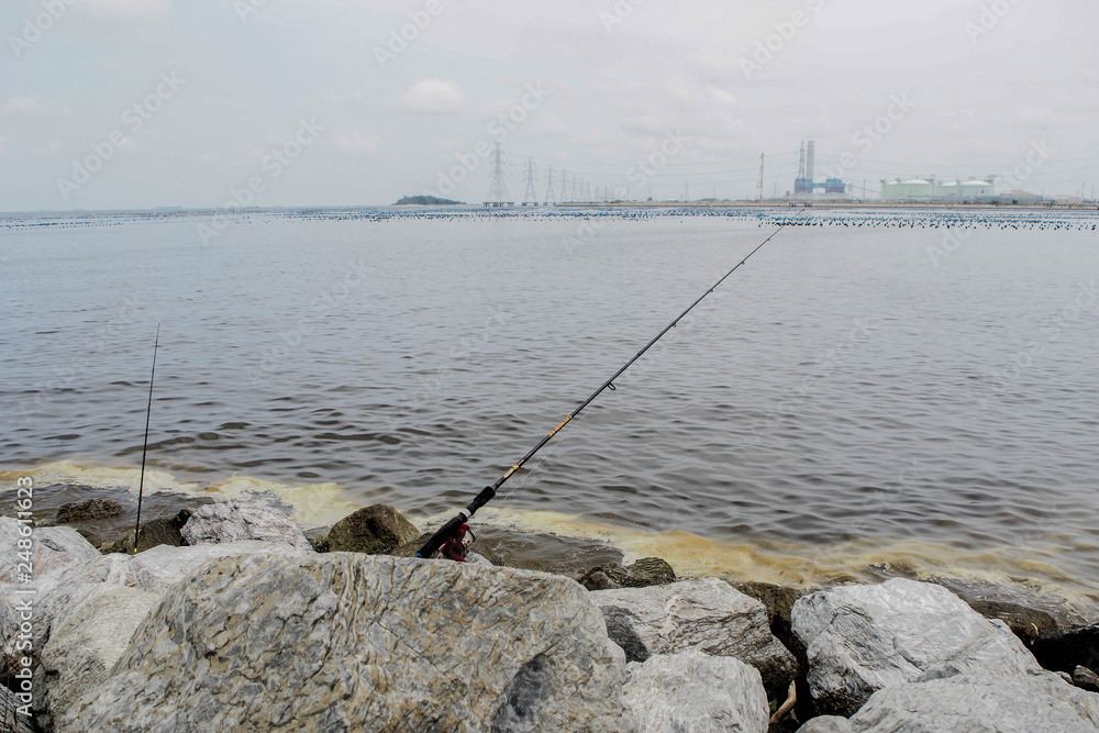 Sea view in the sky with the fishing rod on the coast reef Sea view in the sky with the fishing rod on the coast reef