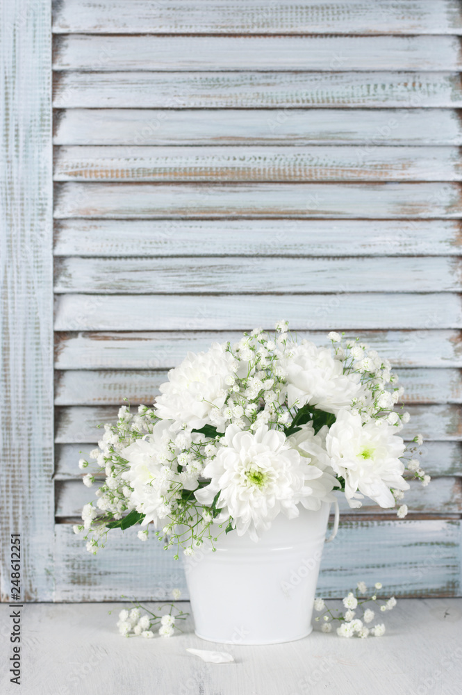 White flowers bouquet against wooden shutters White flowers bouquet against wooden shutters