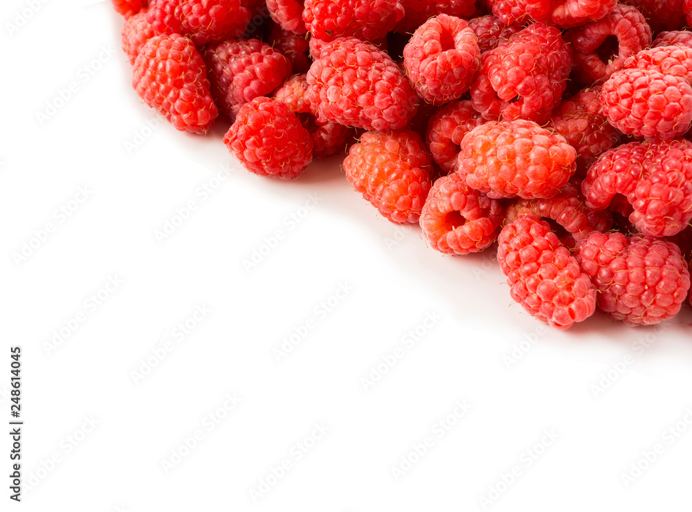 Fresh raspberries closeup on white background. Top view. Background of red berries. Various fresh summer fruits. Red raspberries. Red food. Berries at border of image with copy space for text. Fresh raspberries closeup on white background. Top view. Background of red berries. Various fresh summer fruits. Red raspberries. Red food. Berries at border of image with copy space for text.