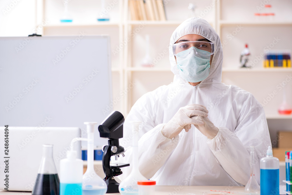 Young handsome chemist working in the lab Young handsome chemist working in the lab