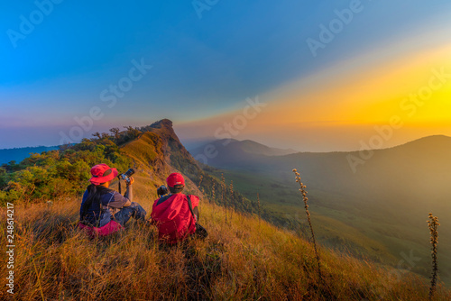 2 female tourists watching the sunset in the mountains, Monjong, Chiang Mai, Thailand photo