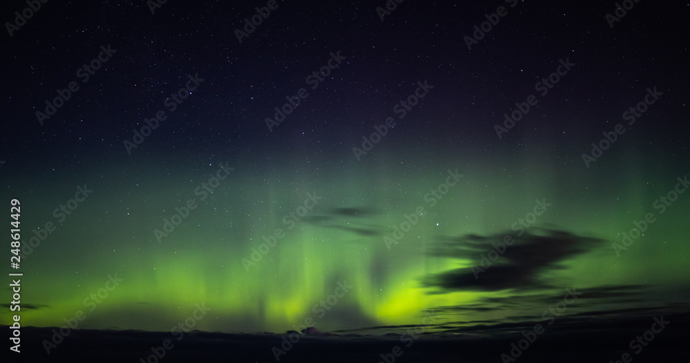 North lights Aurora Borealis seen from Atlantic Ocean road in winter night. Norwegian wintertime.