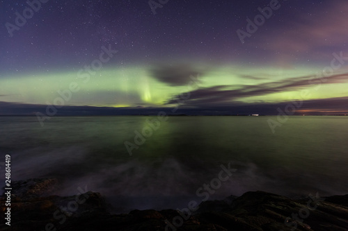 North lights Aurora Borealis seen from Atlantic Ocean road in winter night. Norwegian wintertime.