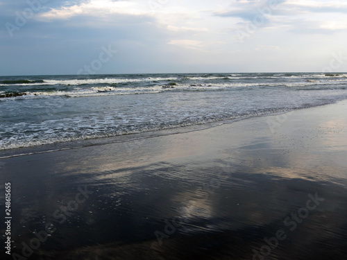 Clouds are reflected in surf waves  Rimini   Italy  Adriatic sea.