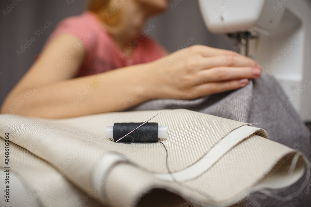 Fototapeta premium Woman working with the machine for sewing. Sewing Process