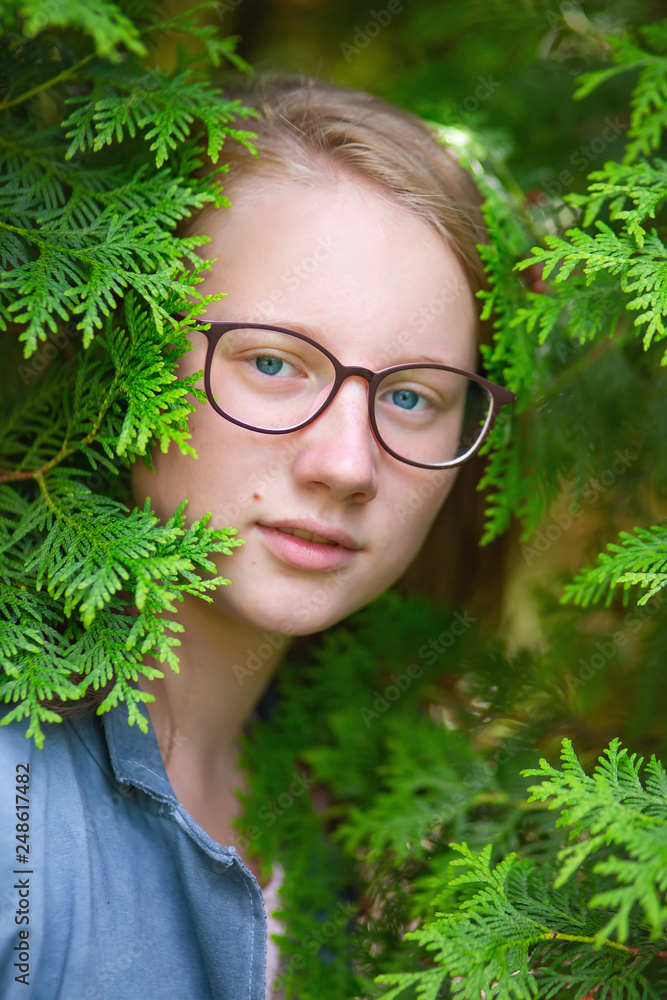 Portrait of a girl in the bushes thuja Portrait of a girl in the bushes thuja