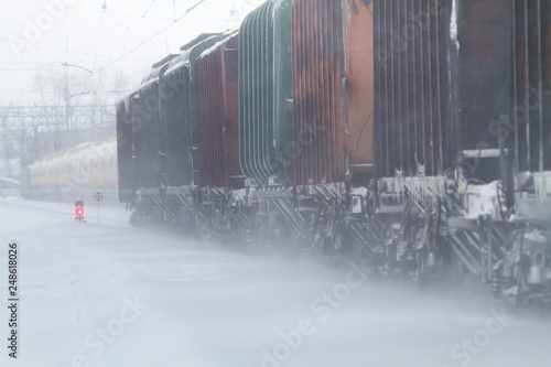 freight train rides on the railway in winter photo