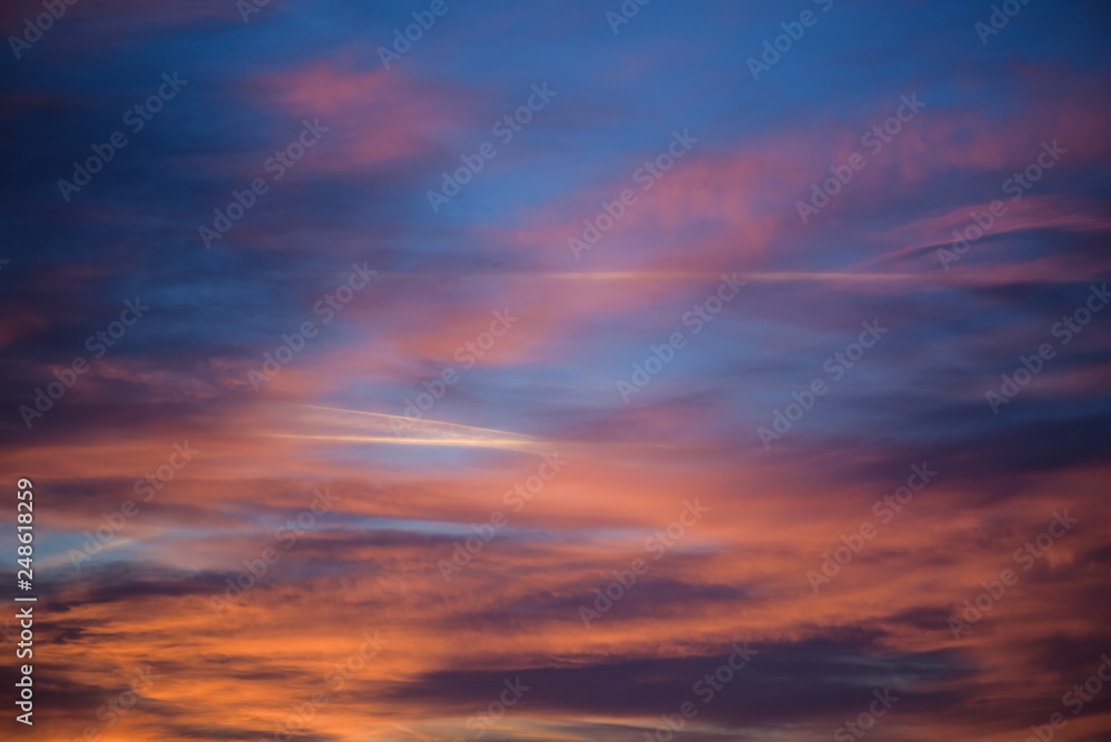  Sunset sky with clouds. Golden sunlight  for your idea of web header. Cloudy landscape for background in serenity colors - blue, violet, yellow and pink tone.