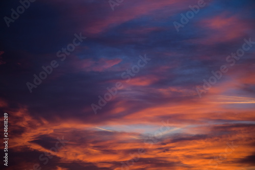  Sunset sky with clouds. Golden sunlight for your idea of web header. Cloudy landscape for background in serenity colors - blue, violet, yellow and pink tone.