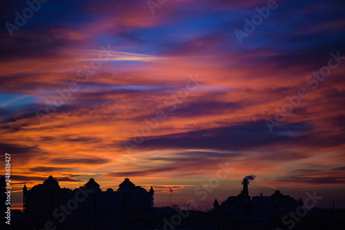  Sunset sky with clouds. Golden sunlight  for your idea of web header. Cloudy landscape for background in serenity colors - blue  violet  yellow and pink tone.