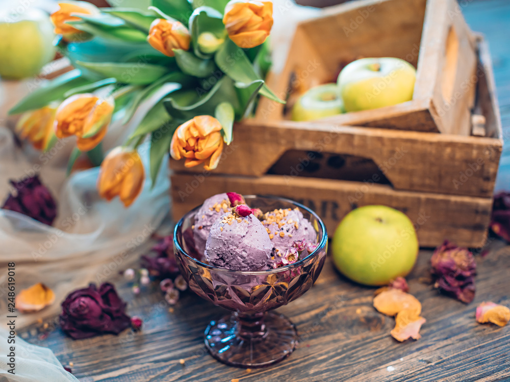 Lilac ice cream with nuts decorated with flowers Lilac ice cream with nuts decorated with flowers