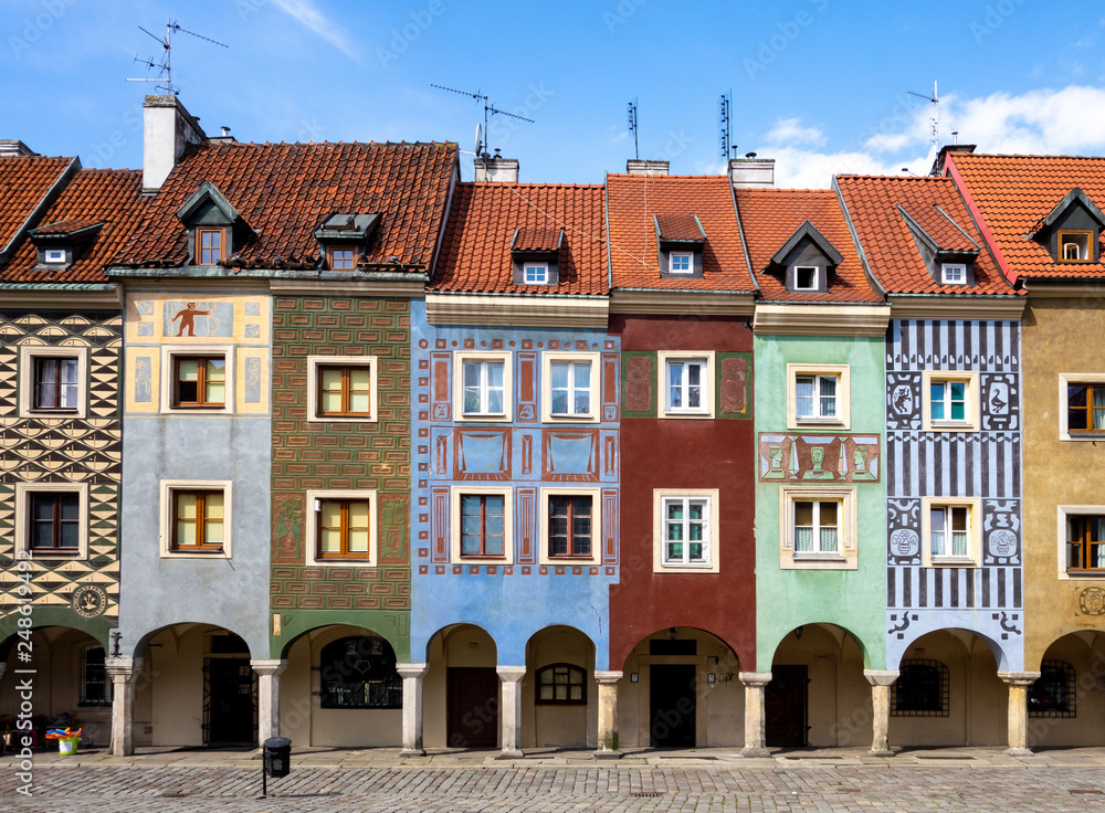 Colourful historical houses with ornaments and an arcade at the town square called Stary Rynek in Poznan Colourful historical houses with ornaments and an arcade at the town square called Stary Rynek in Poznan