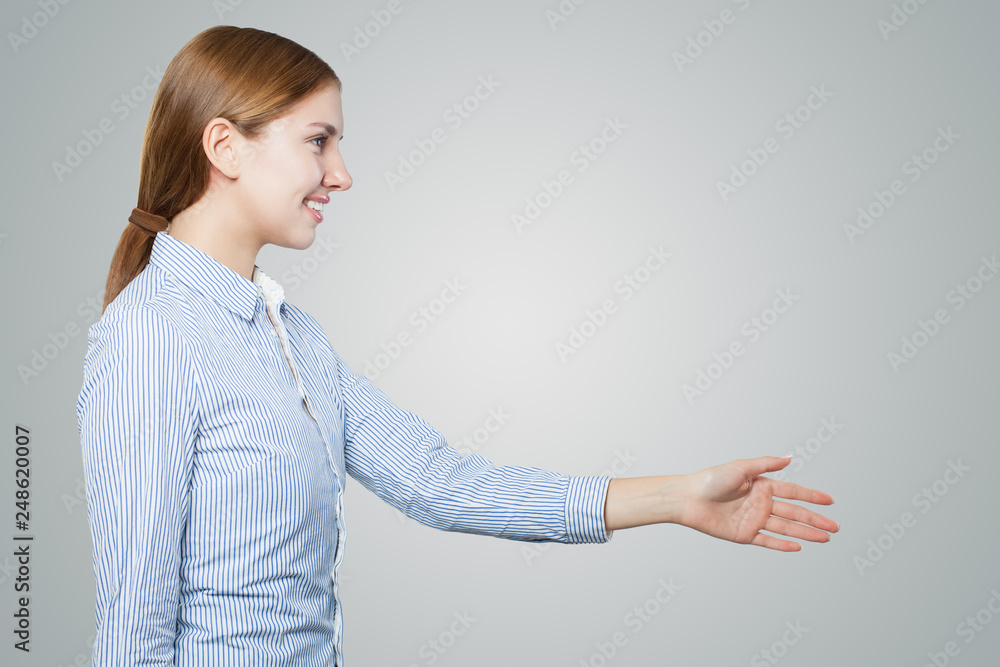 Friendly woman shaking hand on white background with copy space. Handshake woman