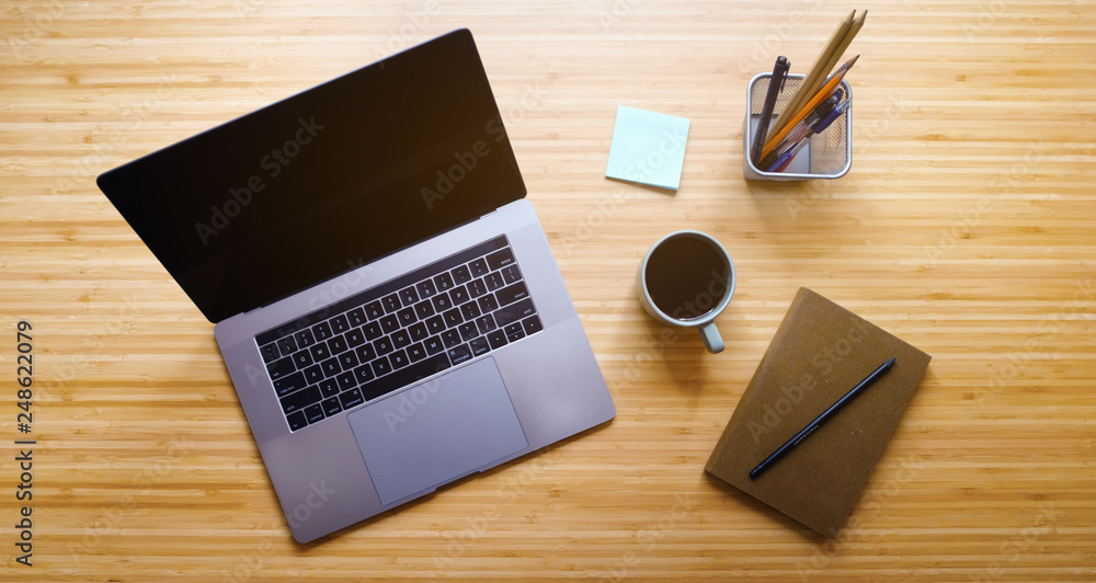 Creative Professional Workspace. Workplace Aerial Top View. Modern Wooden Table Desk with Laptop, Coffee Mug, Notepad, Lamp, Sketchbook, Pencil, Sticky Notes. Flat Lay. Creative Professional Workspace. Workplace Aerial Top View. Modern Wooden Table Desk with Laptop, Coffee Mug, Notepad, Lamp, Sketchbook, Pencil, Sticky Notes. Flat Lay.