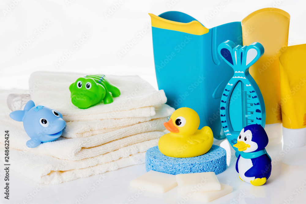Still life with baby hygiene and bath items,    towel, pacifier, rubber toy, thermometer - obrazy, fototapety, plakaty 