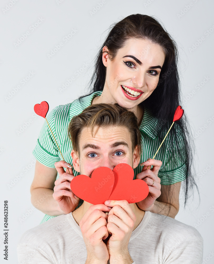 Man and girl in love. Valentines day and love. Happy together. Romantic ideas celebrate valentines day. Valentines day concept. Man and woman couple in love hold red paper heart valentines cards Man and girl in love. Valentines day and love. Happy together. Romantic ideas celebrate valentines day. Valentines day concept. Man and woman couple in love hold red paper heart valentines cards