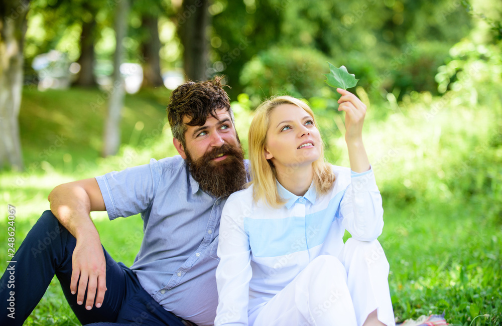 Woman enjoy relax nature background. Pure nature. Couple with green leaf relax natural environment. Couple bearded man and woman enjoy nature while sit on green grass meadow. Nature beauty concept Woman enjoy relax nature background. Pure nature. Couple with green leaf relax natural environment. Couple bearded man and woman enjoy nature while sit on green grass meadow. Nature beauty concept