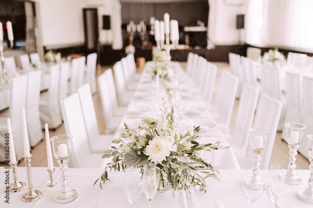 Wedding table decorated with bouquet and candles Wedding table decorated with bouquet and candles