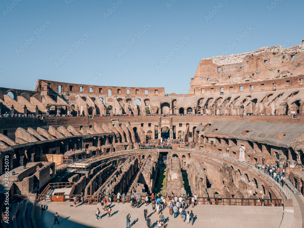 Collosseum in Rome, Italy with many tourists on a beautiful sunny day