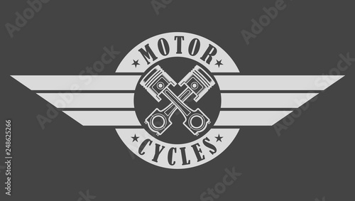 Biker emblem pistons wings and text on gray background