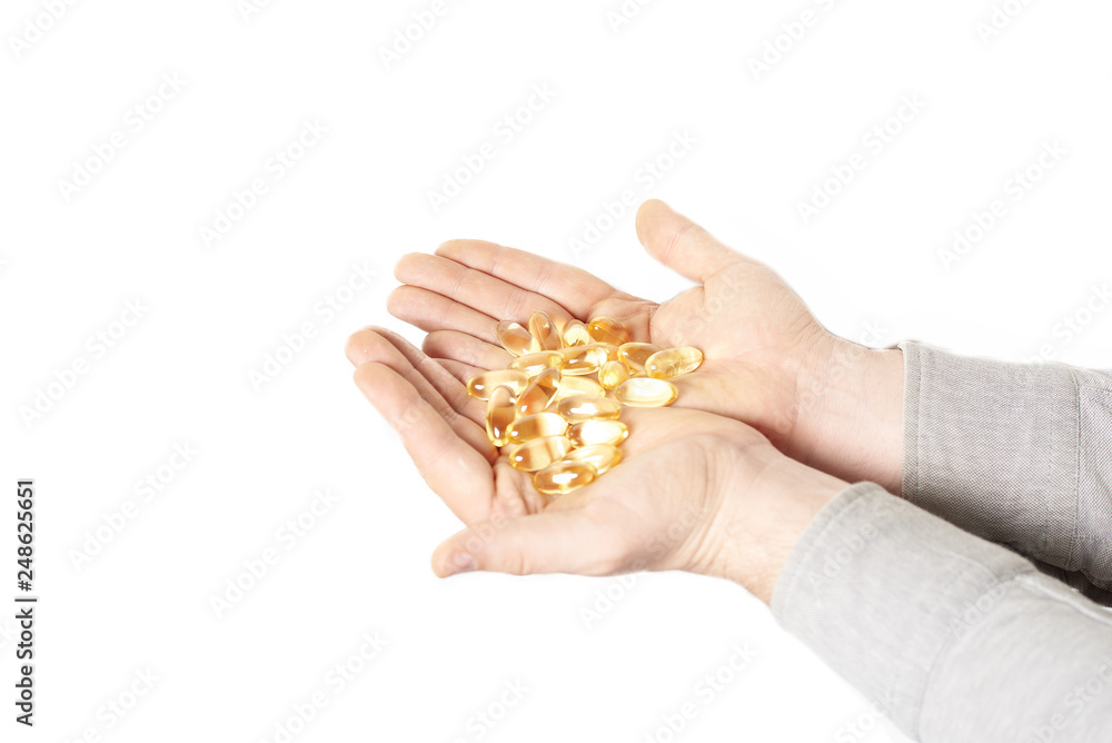 pills in male hand closeup on white background pills in male hand closeup on white background