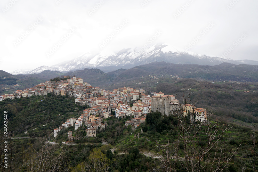 winter in Calabria - village with snow covered mountain in the background