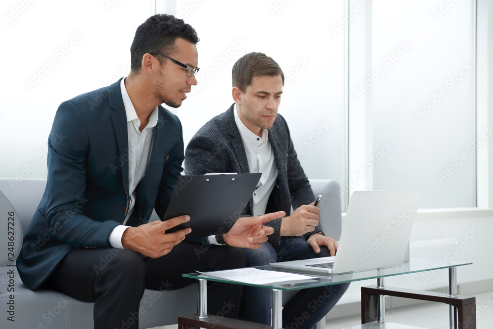 business partners discussing the terms of the new contract. business partners discussing the terms of the new contract.
