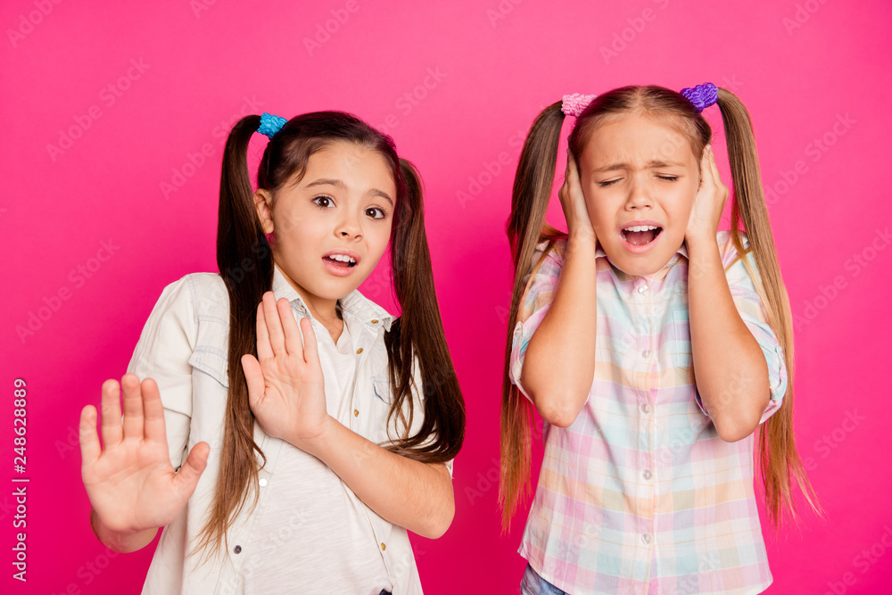 Close up photo two little age girls hands arms head palms enough deny please stop moves terrible head ache wearing casual jeans denim checkered plaid shirts isolated rose vivid bright background Close up photo two little age girls hands arms head palms enough deny please stop moves terrible head ache wearing casual jeans denim checkered plaid shirts isolated rose vivid bright background
