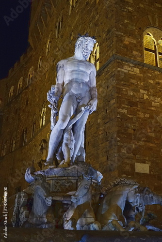 Fountain of Neptune at night in Florence, Italy photo