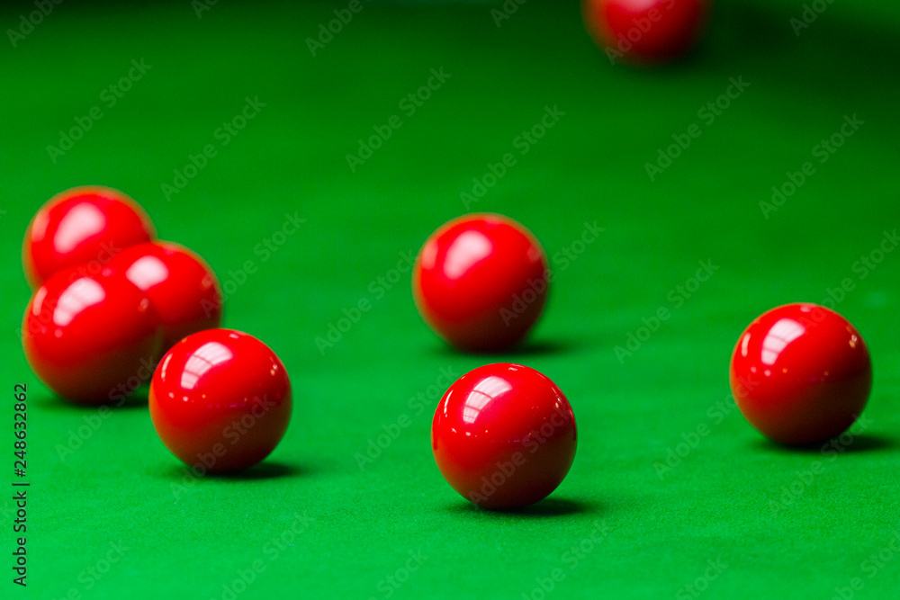 Red snooker ball on the green snooker table at snooker club Red snooker ball on the green snooker table at snooker club