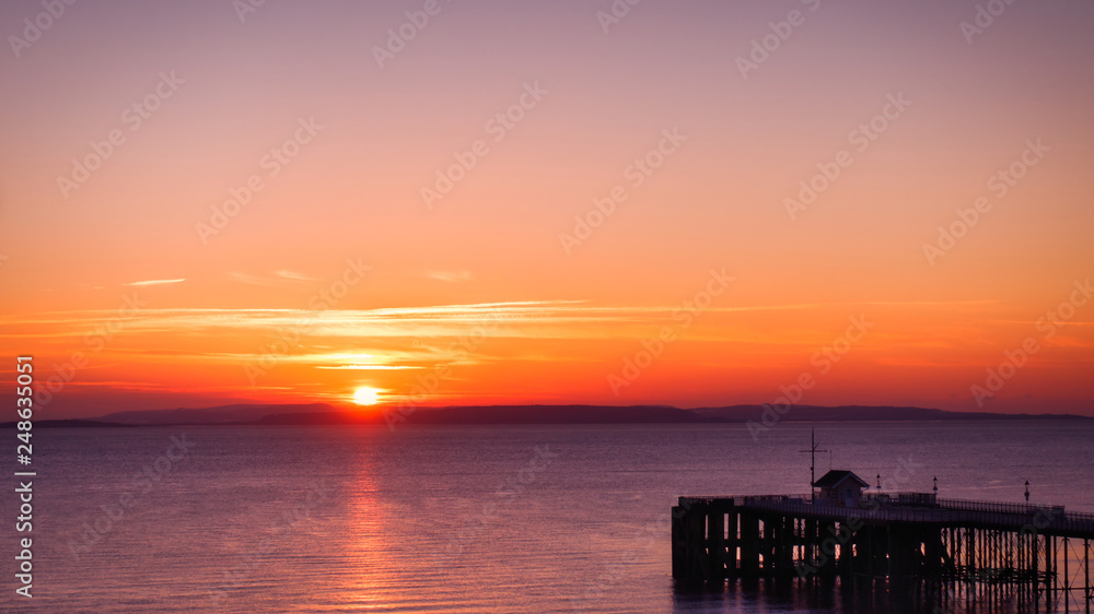 Sunrise in Orange and Magenta over the Sea and Penarth Pier