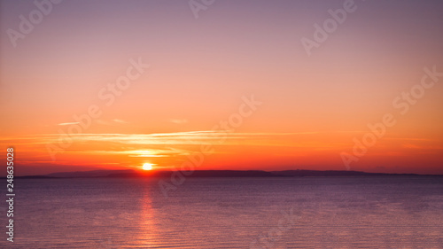 Beautiful Sunrise over the Sea and Sky in Magenta Colors