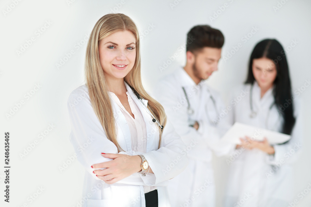 serious therapist with a clipboard while standing in clinic serious therapist with a clipboard while standing in clinic