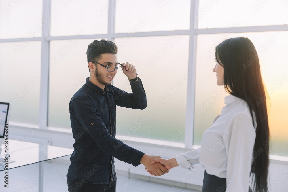 welcome handshake of business people in the office. welcome handshake of business people in the office.