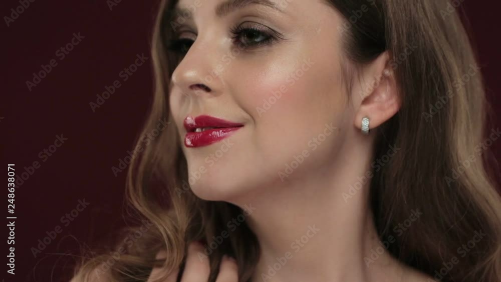 Beautiful brunette model with curls, classic makeup and sexy red lips. Beautiful brunette model with curls, classic makeup and sexy red lips.