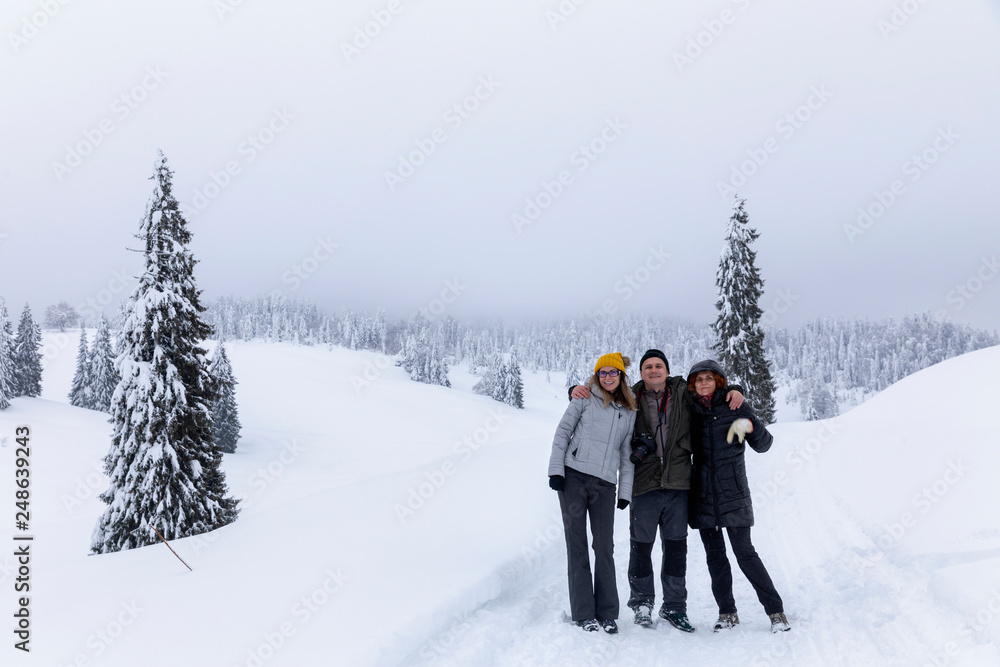 Friends on a mountain hike in the winter holiday