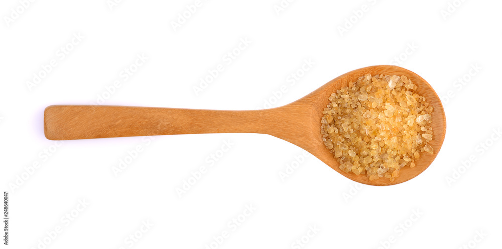 brown sugar in a wooden spoon isolated on white brown sugar in a wooden spoon isolated on white