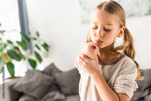 Upset kid blowing on wound at home