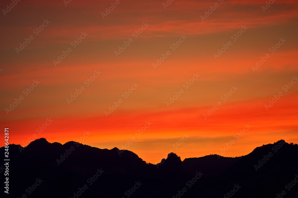 Twilight sunset with silhouette mountains background. Twilight sunset with silhouette mountains background.
