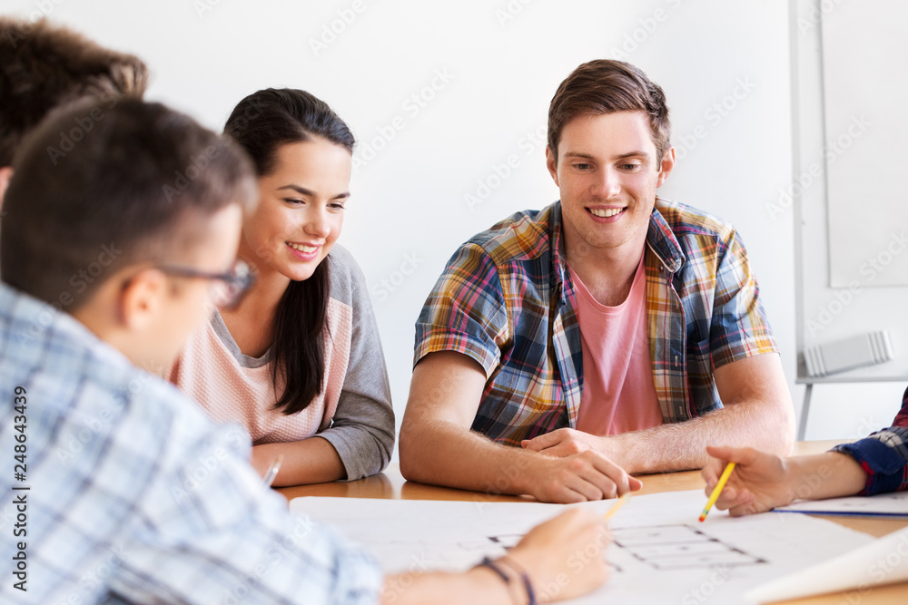 education, architecture and people concept - group of smiling students with blueprint meeting indoors education, architecture and people concept - group of smiling students with blueprint meeting indoors