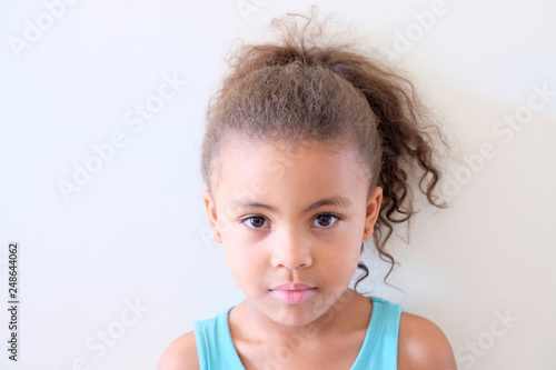 Cute girl relaxing on clean background wall
