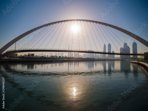 Panorama of the city early in the morning at dawn with a bridge over the city channel Dubai Greek.
