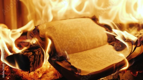 The book burns in the fire of the fireplace photo