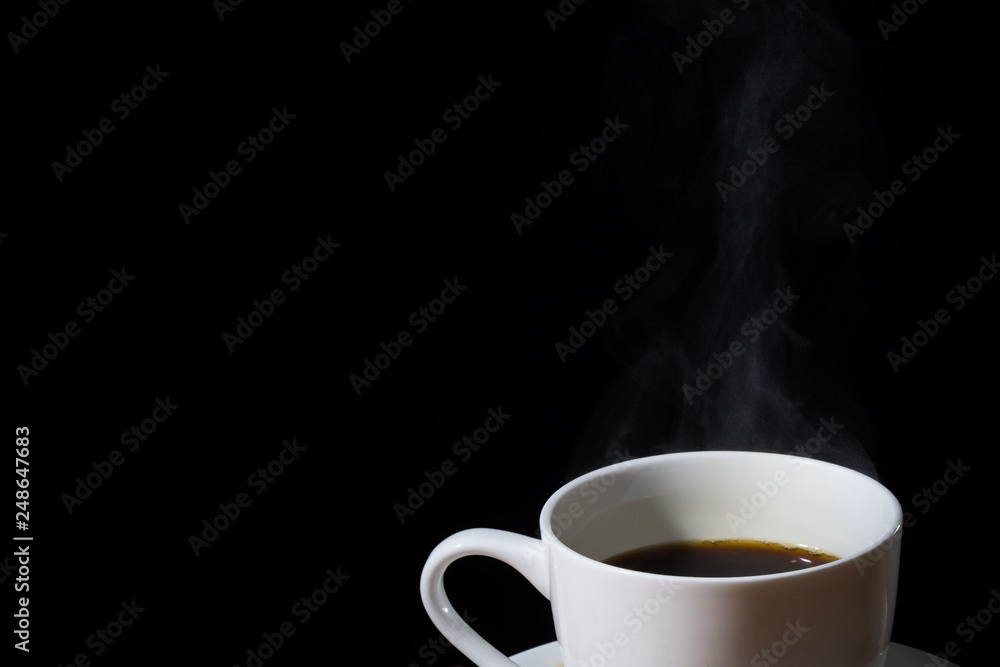 White cup of brewed coffee with steam or vapor and isolated in black. White cup of brewed coffee with steam or vapor and isolated in black.