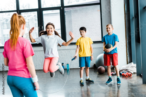 Photography Preteen kids jumping with skipping rope in gym