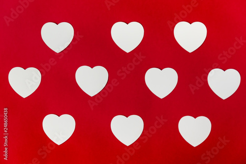 White hearts on a red background